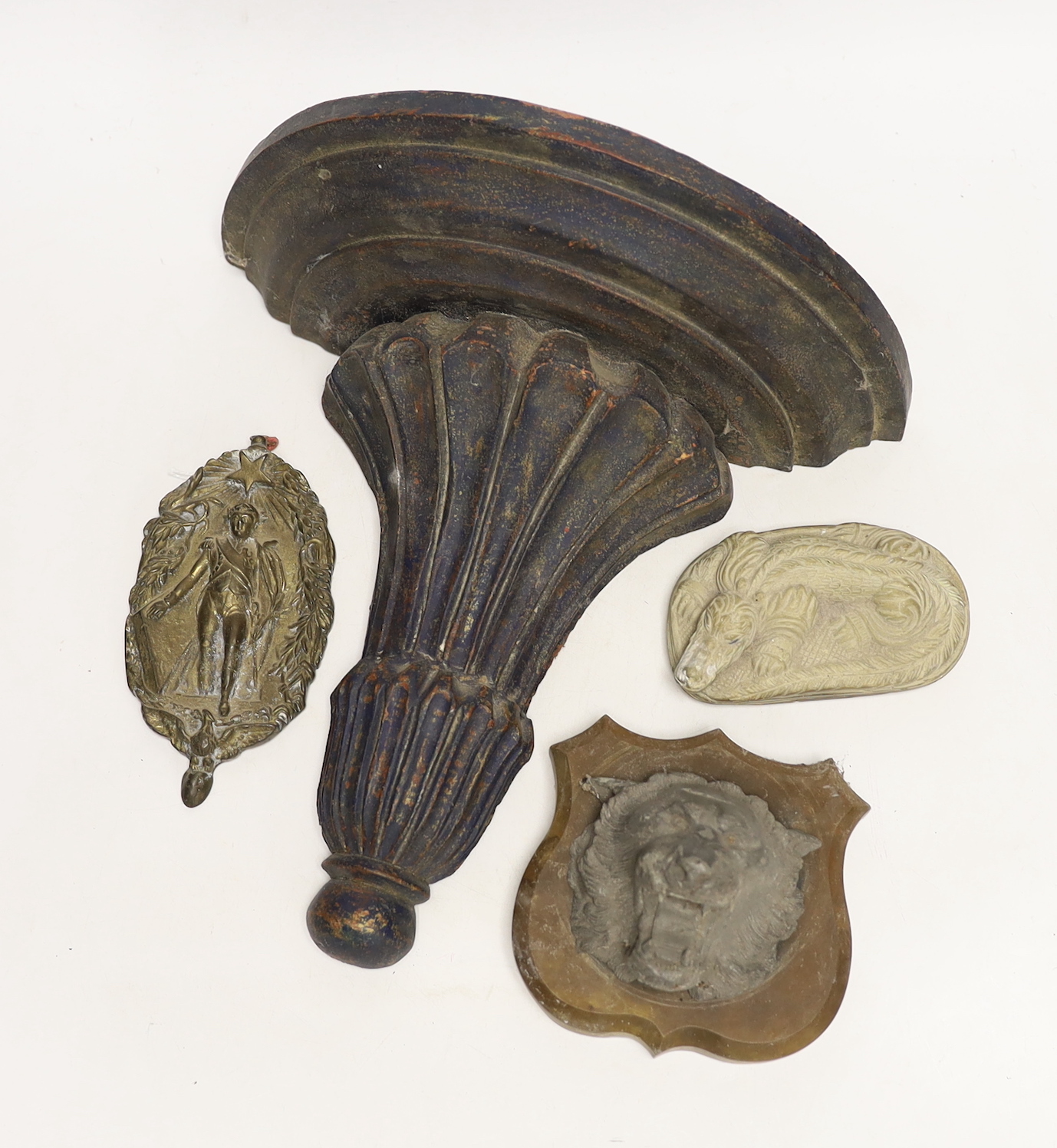 Sundry items including a wood bracket, a crocodile carving, a lion mask and a wall plaque depicting Napoleon